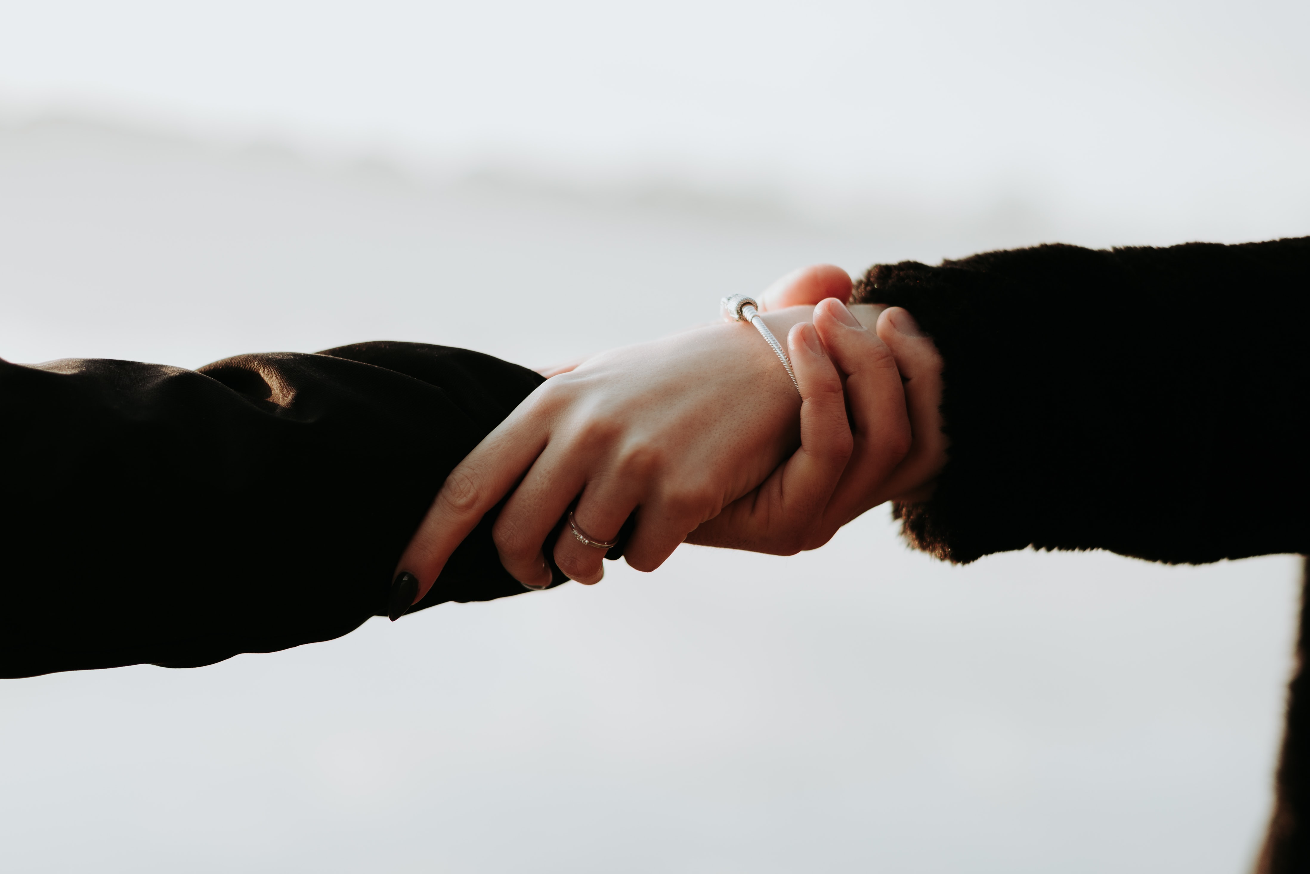 Two people holding hands